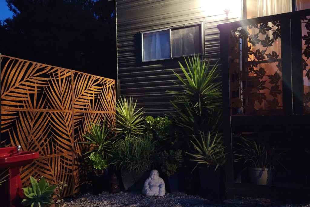 Exterior view of a peaceful treatment room surrounded by natural elements, inviting a sense of calm and holistic healing from the outside in.