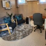 Counselling room Comfortable client seating area in a softly lit counselling room, featuring warm tones, cushions, and a peaceful atmosphere that fosters safety and trust.