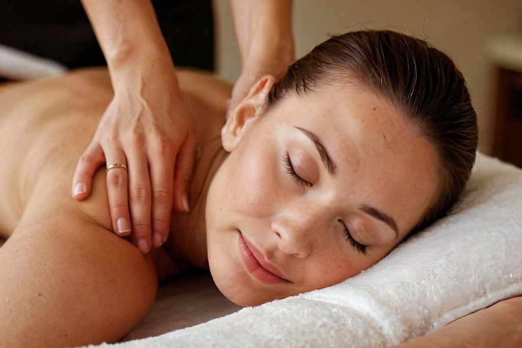 Relaxation shoulder massage – woman blissfully unwinding Woman receiving a gentle shoulder massage with eyes closed, facial expression calm and peaceful, symbolising deep relaxation and the release of stress and worry.